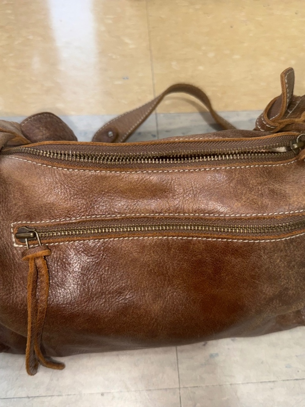 brown leather Roots handbag